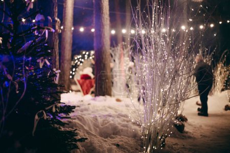Photo for A cheerful family celebrates the holiday season with Christmas decorations and Santa Claus. Atmospheric distortion, hot air distortion, heat distortion, air refraction. - Royalty Free Image