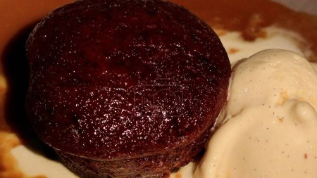 Photo for Sticky Date Pudding with Hot Butterscotch Sauce and Vanilla Ice Cream. - Royalty Free Image