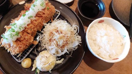 Japanese tonkatsu is a breaded, deep-fried pork cutlet, traditionally served with cabbage, rice and sour sauce. Crispy on the outside, tender inside.