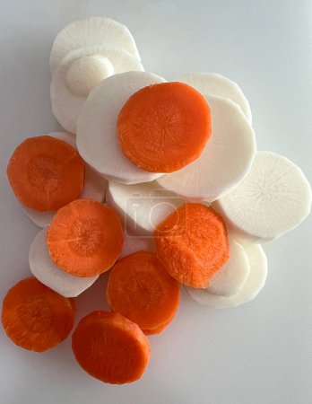 Raw Radish and Carrot Slices for Home Cooking.