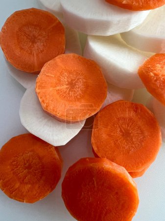 Raw Radish and Carrot Slices for Home Cooking.