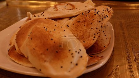 A taste of Jordan freshly baked balloon bread on dining table.