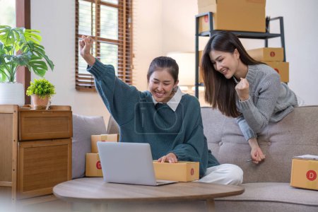 Photo for Business owner concept. Young two asian woman smiling happy using laptop working and checking customers online order products packaging in modern home office.. - Royalty Free Image