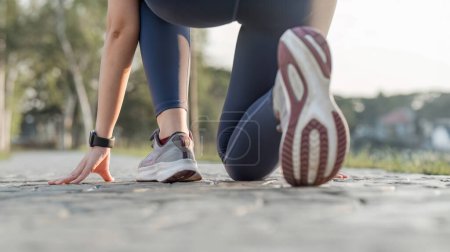 Photo for Close-up photo of women is sports shoes Get ready for a run on a bright spring day.. - Royalty Free Image