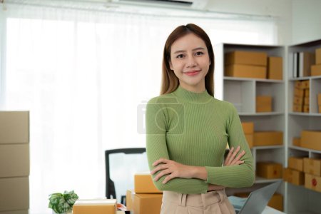 Portrait of Starting small businesses SME owners female entrepreneurs working on receipt box and check online orders to prepare to pack the boxes, sell to customers, SME business ideas online..