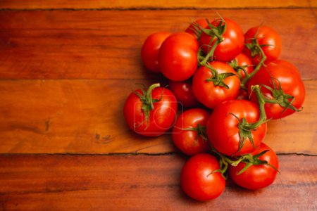Photo for Heap of tomatoes on wooden table, with negative space on left, t - Royalty Free Image