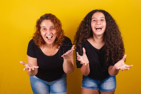 Photo for Grandmother and niece, Brazilian, Latin American, curls, afro hair, curly, Face of surprise, surprised, wow, amazing, family photo, beautiful. Mother's Day, Fraternity, Love. - Royalty Free Image