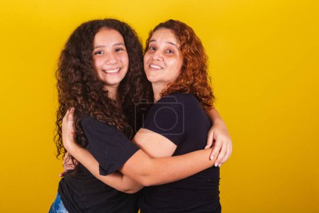 Photo for Grandmother and niece, Brazilian, Latin American, curls, afro hair, curly, smiling, hugging, family photo, beautiful. Mother's Day, Fraternity, Love. - Royalty Free Image