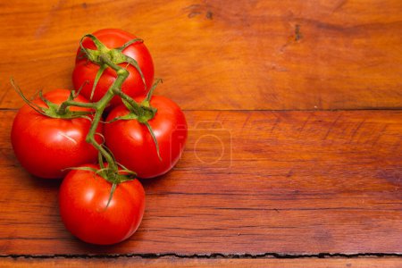 Photo for Pile of tomatoes on wooden table - Royalty Free Image