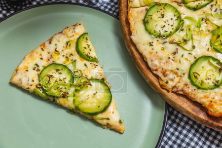Photo for Delicious vegetarian cucumber pizza next to cucumber pizza slice, home pizza, brazilian pizza. Close up of pizza. - Royalty Free Image