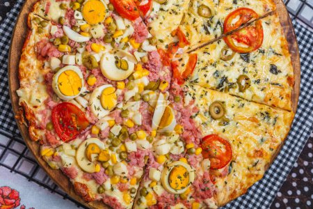 Photo for Portuguese pizza and margarita pizza together in one pizza. sliced and divided,baked pizza, home pizza. - Royalty Free Image