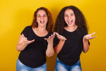 Photo for Grandmother and niece, Brazilian, Latin American, curls, afro hair, curly, Face of surprise, surprised, wow, amazing, family photo, beautiful. Mother's Day, Fraternity, Love. - Royalty Free Image