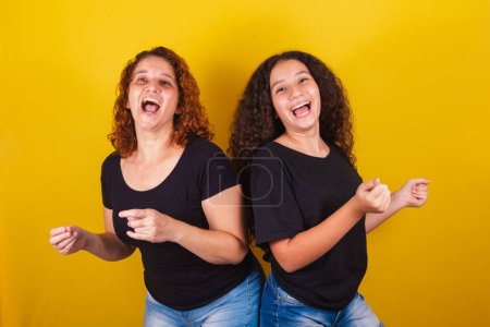 Photo for Grandmother and niece, Brazilian, Latin American, curls, afro hair, curly, dancing, happy, playing, dancing, family photo, beautiful. Mother's Day, Fraternity, Love. - Royalty Free Image