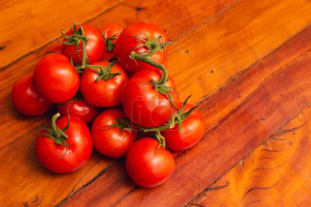 Photo for Heap of tomatoes on wooden table, composition in the center, tom - Royalty Free Image