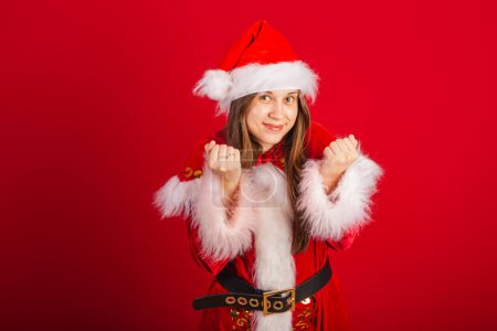 Photo for Caucasian, Brazilian woman in Christmas clothes, Santa Claus. inviting hands. - Royalty Free Image