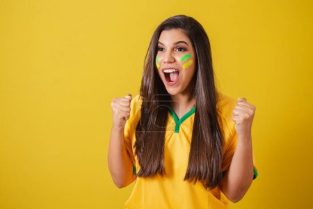 Photo for Woman supporter of Brazil, 2022 world cup, football championship, screaming goal, celebrating team victory and goal. - Royalty Free Image