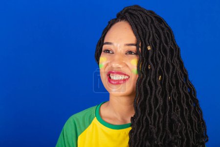 Photo for Young black Brazilian woman, soccer fan. close-up photo of smiling teeth. - Royalty Free Image