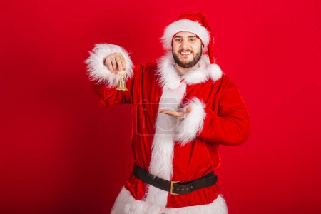 Photo for Caucasian, Brazilian man dressed in Christmas outfit, Santa Claus. holding christmas bell. - Royalty Free Image