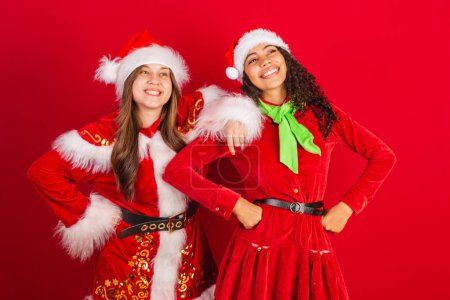 Téléchargez les photos : Deux amis brésiliens, vêtus de vêtements de Noël, Père Noël claus. - en image libre de droit