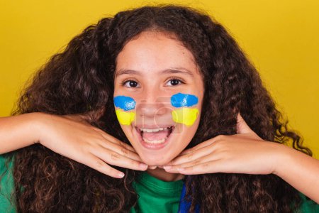 Photo for Brazilian, caucasian girl, football fan, closeup photo, fun facial expression, selfie, grimace. World Cup. Olympics. - Royalty Free Image