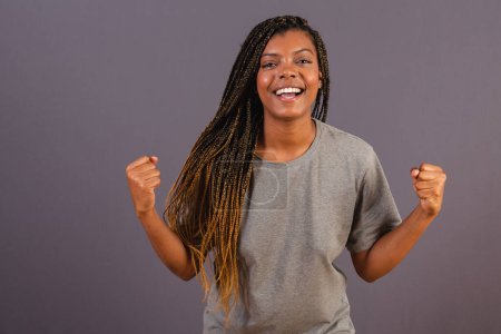 Photo for Young afro brazilian girl, vibrating with hands, celebrating, partying. yes - Royalty Free Image