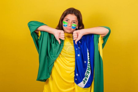 Photo for Brazilian, Caucasian child, thumb down, disapproval, negative, sad, unhappy. World Cup. Olympics. soccer fan - Royalty Free Image