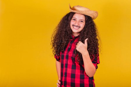 Photo for Caucasian girl, dressed as a boy, party clothes, thumb up, affirmative, approval. Festivals in May, June and July. - Royalty Free Image