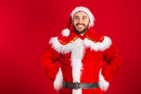 Photo for Brazilian man, dressed in santa claus clothes, hands on waist. - Royalty Free Image
