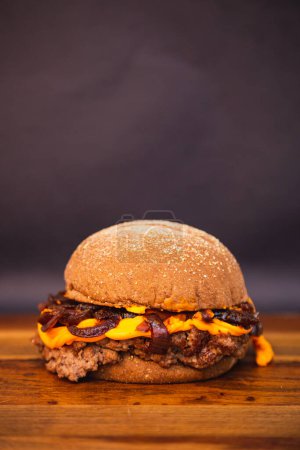 Photo for Delicious beef burger with cheddar cheese and caramelized onions. Australian bread - Royalty Free Image