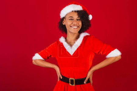 Photo for Beautiful black brazilian woman, dressed as santa claus, mama claus, hands on waist - Royalty Free Image