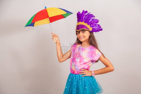 Photo for Beautiful Brazilian girl, child, dressed for carnival in Brazil. dancing with frevo umbrella. - Royalty Free Image