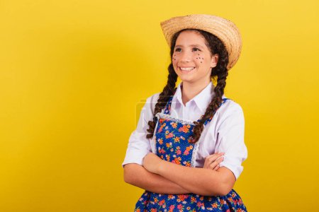 Photo for Girl wearing typical clothes for Festa Junina. Arms crossed, smiling and happy. For the Festival do Arraia - Royalty Free Image