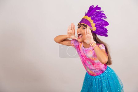 Photo for Beautiful Brazilian girl, child, dressed for carnival in Brazil. shouting, advertising promotion. - Royalty Free Image