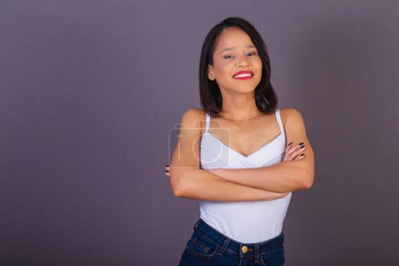 Photo for Young adult woman from northeastern brazil. crossed arms. confident and smiling. - Royalty Free Image