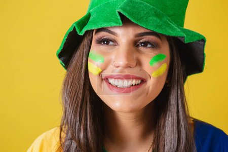 Photo for Close-up photo, Woman supporter of Brazil, world cup 2022, focus on the look, on the smile. wearing cheerleading outfit, flag and hat. - Royalty Free Image