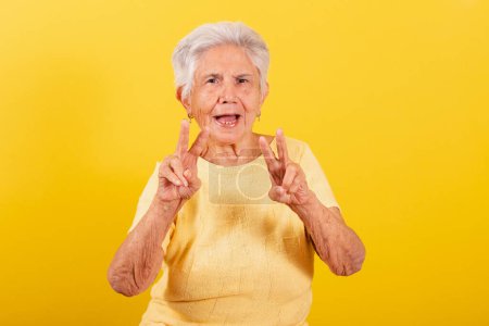 Photo for Old lady, symbol of peace and love with fingers, cool. happy, joyful, victory. - Royalty Free Image