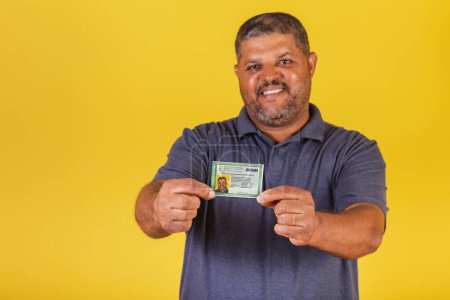 Photo for Brazilian black man, adult with identity card, RG. Brazilian document. - Royalty Free Image