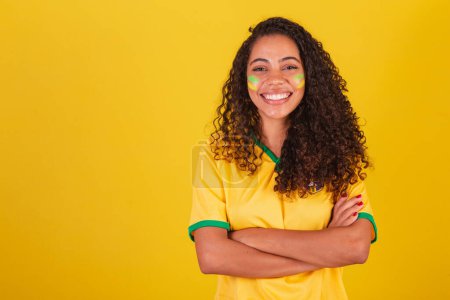 Photo for Young black Brazilian woman, soccer fan. smiling, conveying confidence. - Royalty Free Image