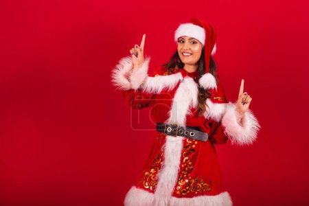 Photo for Brazilian woman dressed in Christmas clothes, Santa Claus. dancing. - Royalty Free Image