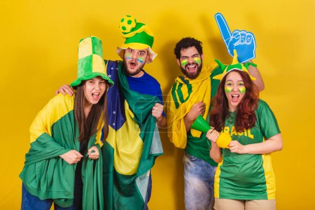 Photo for Group of friends, soccer fans from brazil, using brazil flag, horn and espupa finger. screaming Goal! Celebrating victory. - Royalty Free Image
