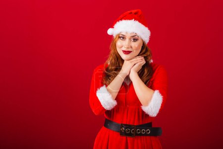 Photo for Beautiful Brazilian red-haired woman, dressed in Christmas clothes, Santa Claus. looking at photo, hopeful and cute. - Royalty Free Image