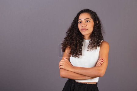 Photo for Young Brazilian black woman, arms crossed, serious, optimistic. - Royalty Free Image