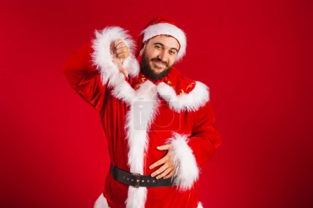 Photo for Brazilian man, dressed in santa claus clothes, dislike sign - Royalty Free Image