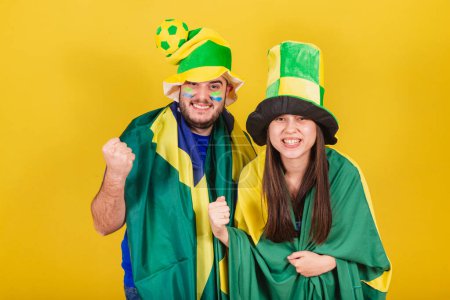 Photo for Couple, soccer fans from brazil, celebrating, vibrating and partying. - Royalty Free Image