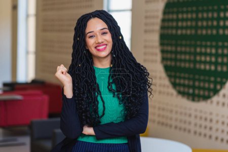Photo for Young black woman, brazilian, entrepreneur, business woman, arms crossed smiling in office. - Royalty Free Image