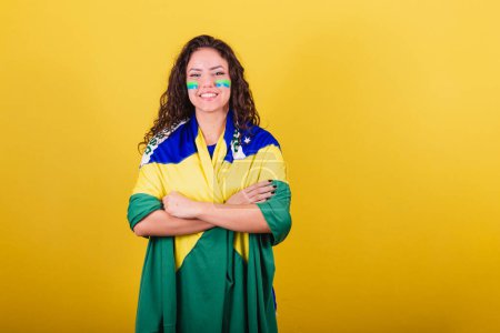 Photo for Woman soccer fan, fan of brazil, world cup, arms crossed, smiling, confident - Royalty Free Image