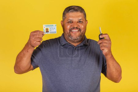 Photo for Brazilian black male, adult with driver's license, Brazilian document, and car key. - Royalty Free Image