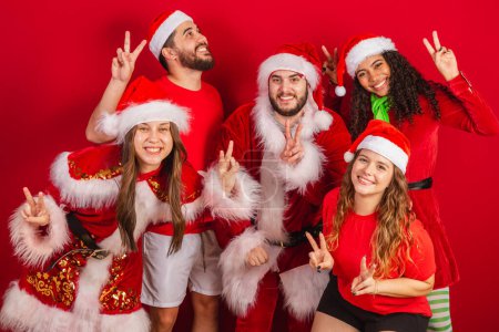Photo for Brazilian friends, with christmas clothes, santa claus. celebrating christmas. - Royalty Free Image