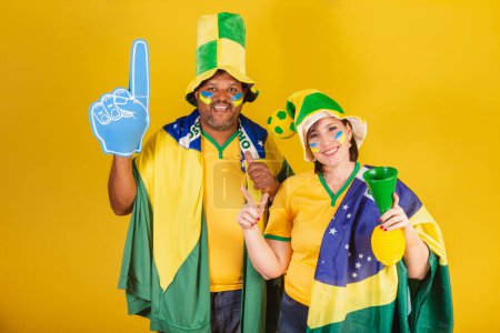 Photo for Couple, red-haired woman and black man, Brazilian soccer fans. - Royalty Free Image