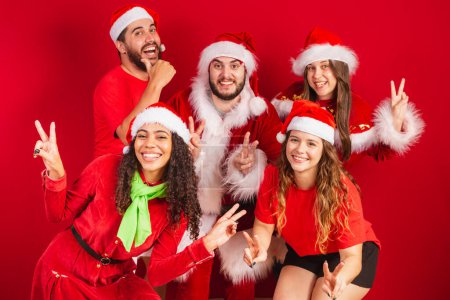 Photo for Brazilian friends, with christmas clothes, santa claus. posing for photo. - Royalty Free Image
